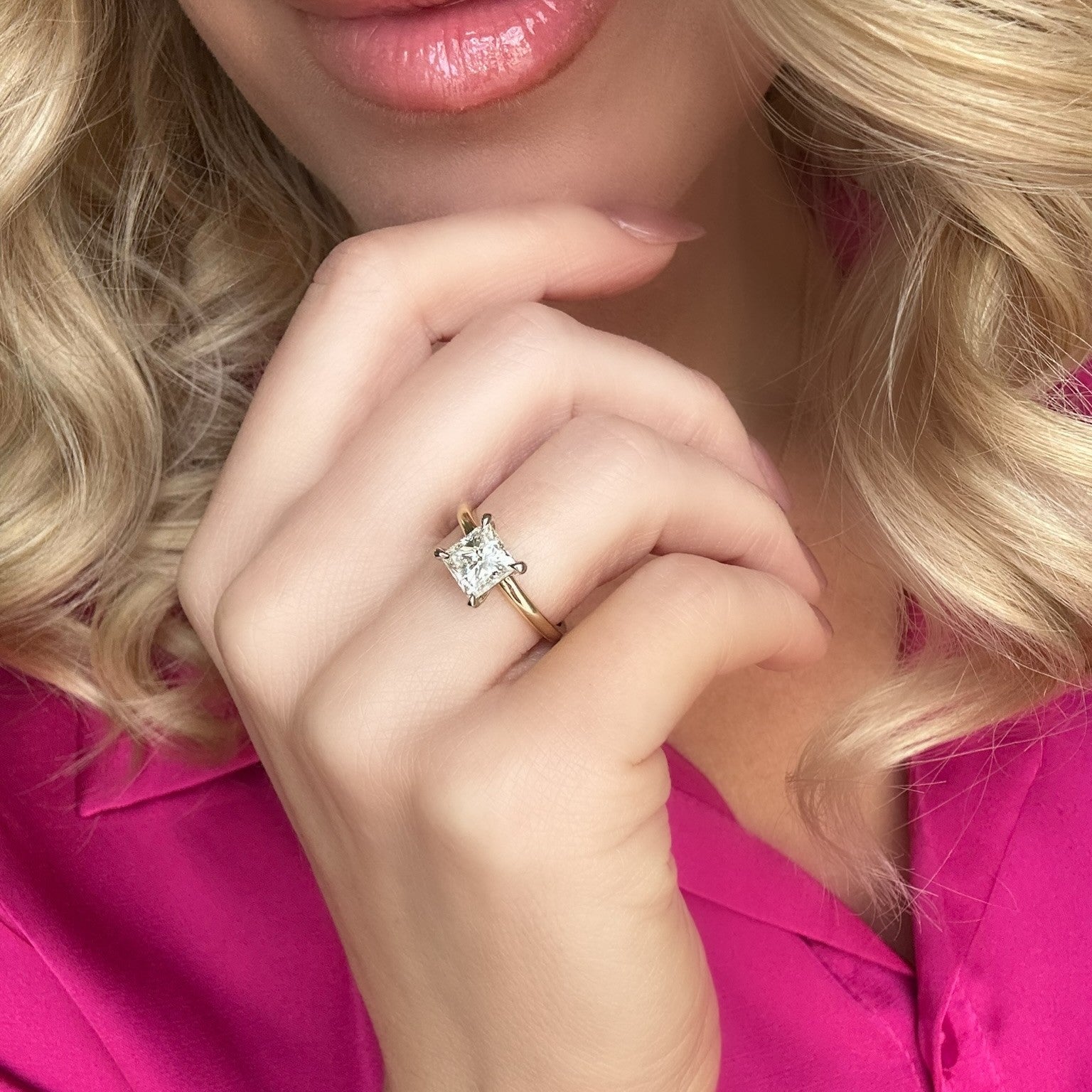 Close up of a 14k Gold Two Tone Princess Cut Diamond Solitaire Ring on a hand