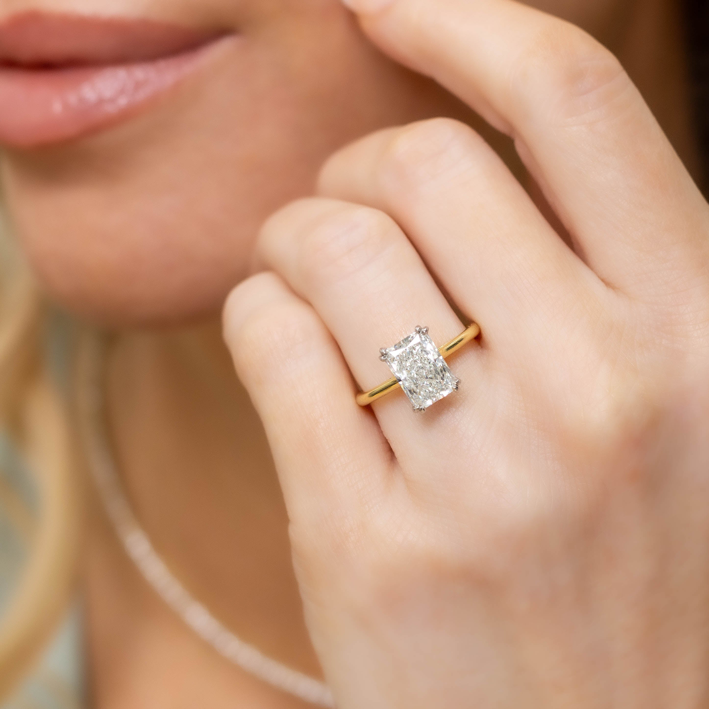 close up of 18k Yellow Gold Lennon Radiant Diamond Solitaire on a hand