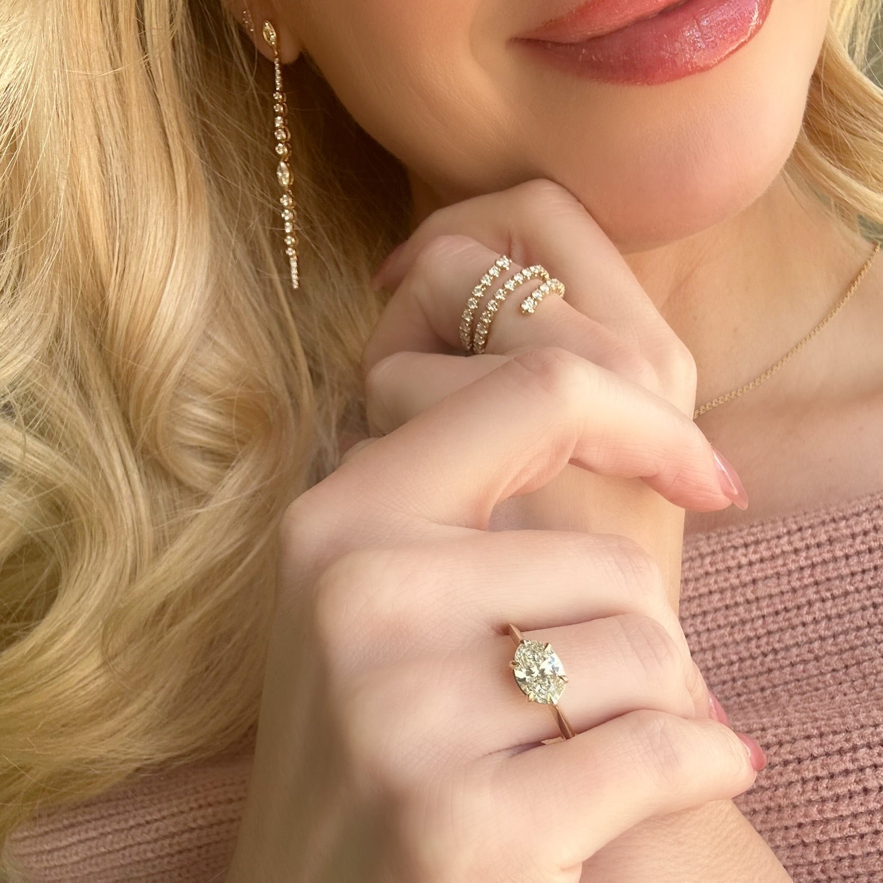 Lifestyle image of a woman wearing our 14k Yellow Gold Oval Diamond East-West Solitaire 1.54 ct