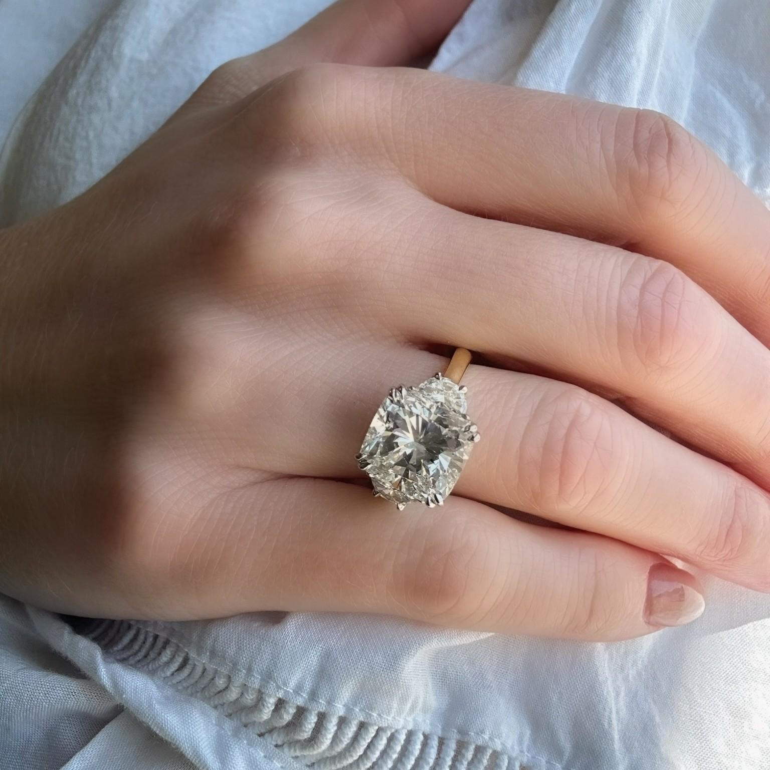 close up of Taylor 18K Yellow Gold Cushion Cut Diamond Three Stone Ring