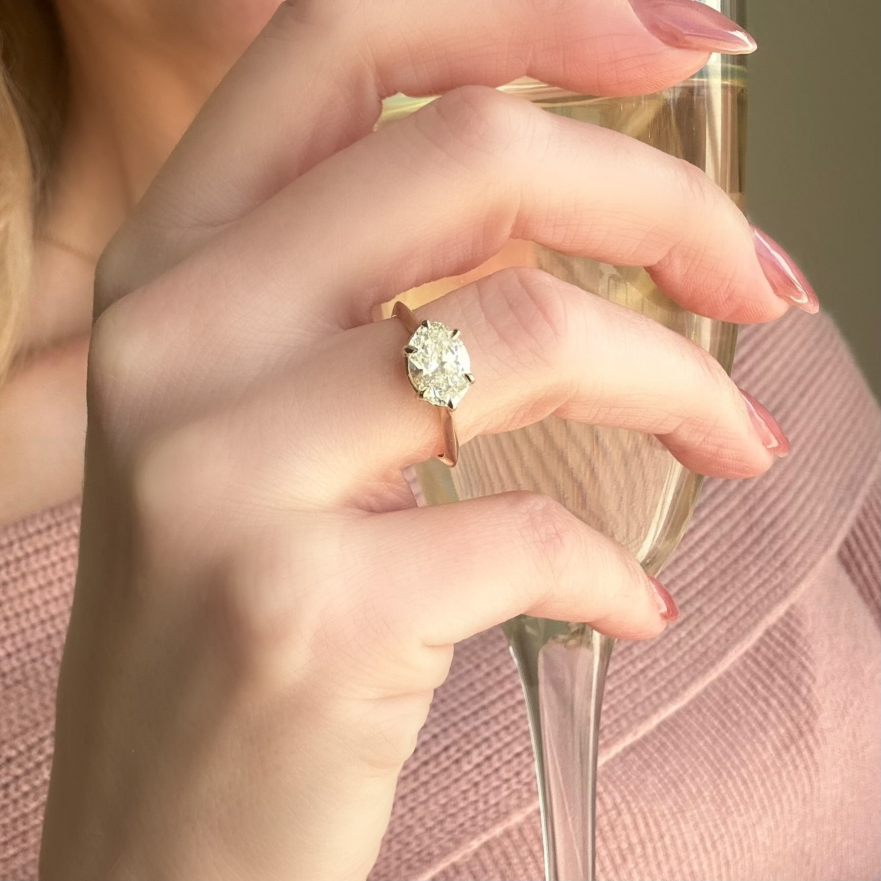 Close up of 14k Yellow Gold Oval Diamond East-West Solitaire 1.54 ct on a hand